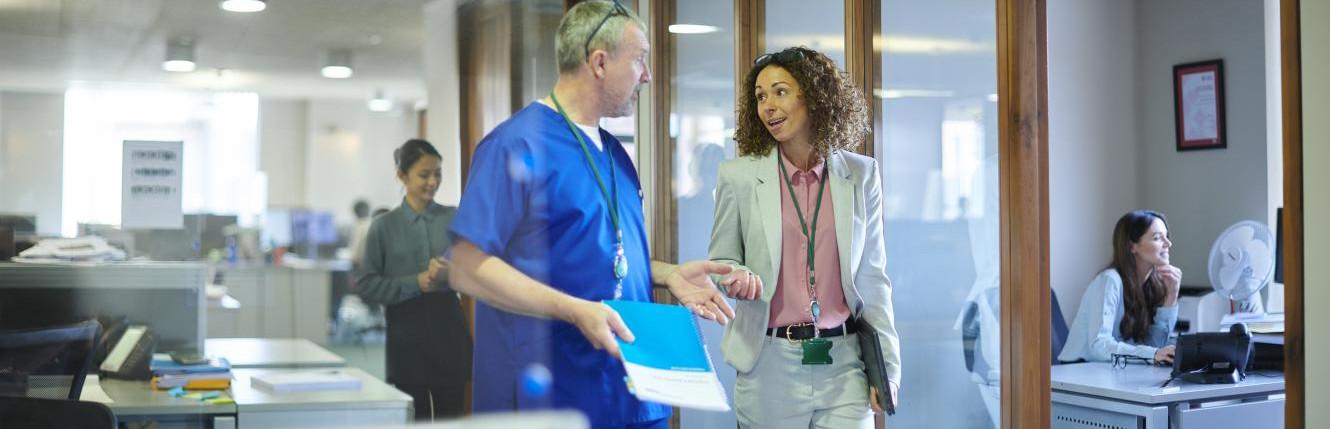 Hospital staff talking to doctor image